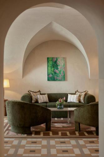 a living room with two couches and a table at Stradom House, Autograph Collection in Kraków