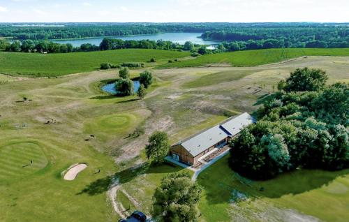 an aerial view of a field with a barn and a lake at 1 Bedroom Amazing Apartment In Binowo in Binowo