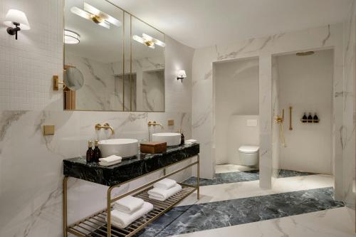 a bathroom with a sink and a toilet at Stradom House, Autograph Collection in Kraków