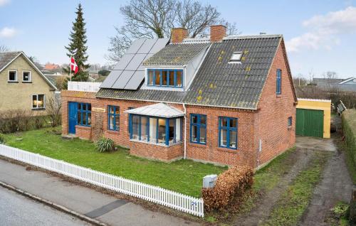 a red brick house with a solar roof at 2 Bedroom Beautiful Home In Kalvehave in Kalvehave