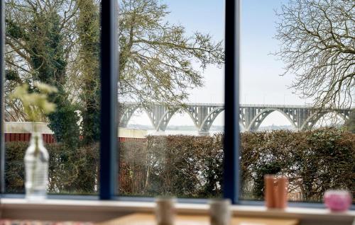 a window with a view of a bridge in the background at 2 Bedroom Beautiful Home In Kalvehave in Kalvehave