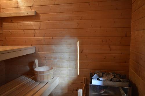 a sauna with a toilet in a wooden wall at Стаи за гости VIVIA in Veliko Tŭrnovo