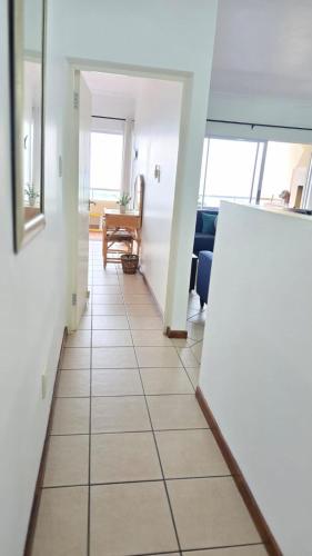 a hallway with a tile floor in a room at 407 L'Escalier Cabanas -Beachfront Paradise in Amanzimtoti