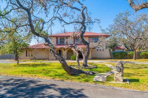 a house with a tree in front of it at Bunk bed private room Ideal for Groups in SHARED home in San Antonio