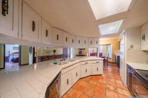a large kitchen with white cabinets and a kitchen island at Bunk bed private room Ideal for Groups in SHARED home in San Antonio