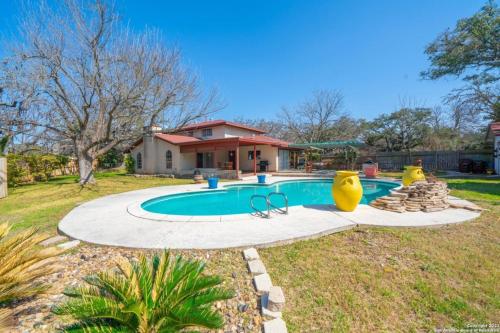 a swimming pool in a yard with a house at Bunk bed private room Ideal for Groups in SHARED home in San Antonio
