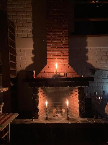 a brick fireplace with two candles in it at Hermosa casa de campo a solo 90min de CDMX in San Lorenzo Octeyuco