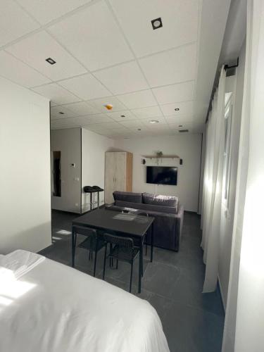 a living room with a table and a couch at Apartamentos - Mirasur in Parla