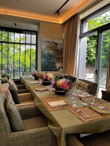 a long table in a room with windows at Madame Crepin in Rochefort