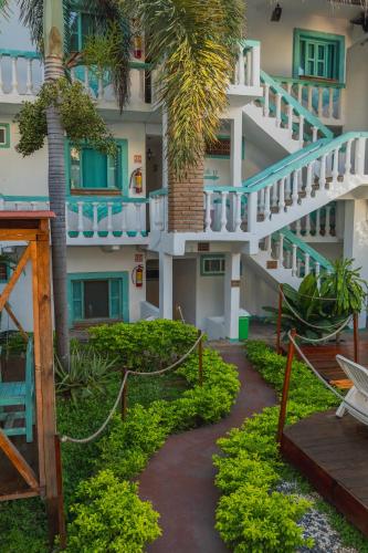 a building with a staircase and palm trees at Hotel Costa 55 Puerto Escondido in Puerto Escondido