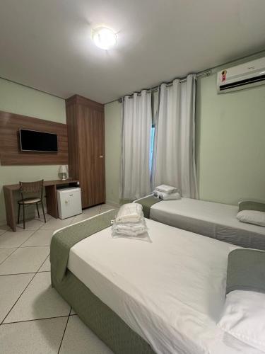 Ένα ή περισσότερα κρεβάτια σε δωμάτιο στο Domus Hotel Torre - Canaã dos Carajás