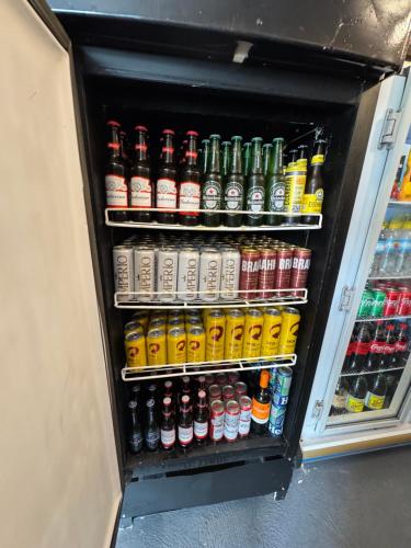a refrigerator filled with lots of different types of drinks at The Wall in Araçatuba
