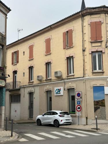 a white car parked in front of a building at Tain centre -T3- wine themed apartment in Tain-lʼHermitage