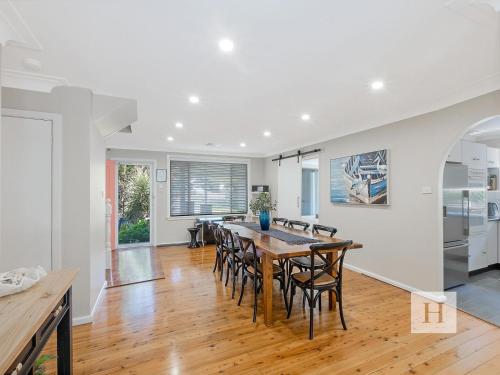 a kitchen and dining room with a table and chairs at The Place in Summerland Point