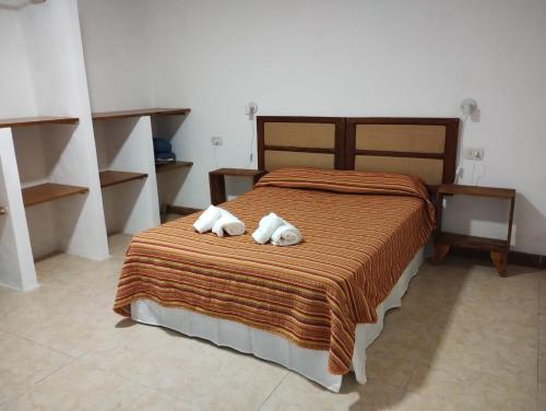 a bedroom with a bed with two towels on it at Casa Poetas in Villa Nueva