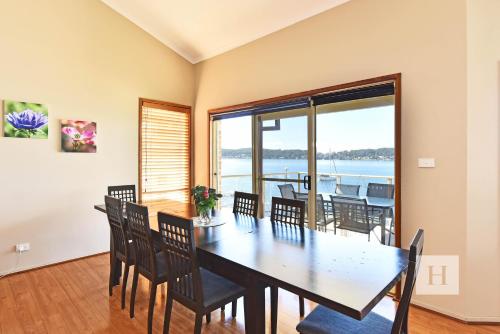 a dining room with a table and chairs at Sparkling Waters in Rathmines