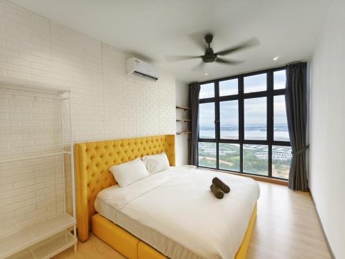 a bedroom with a bed and a large window at Sea View Cozy 2BR Green Haven -Permas Masai CIQ -7 to 9pax in Masai