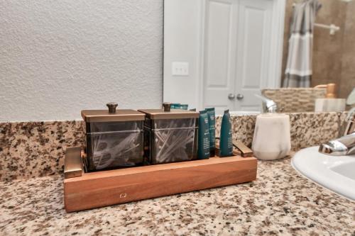 a bathroom counter with a tray with toiletries on it at The Alexan* Walk to NRG* TX Med Center* Downtown in Houston