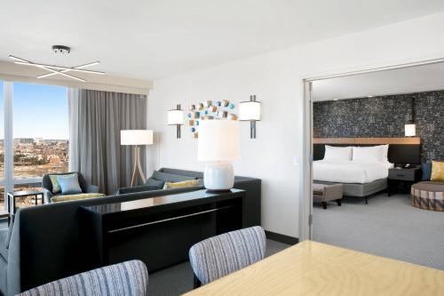 a hotel room with a bed and a living room at Courtyard Boston Downtown/North Station in Boston