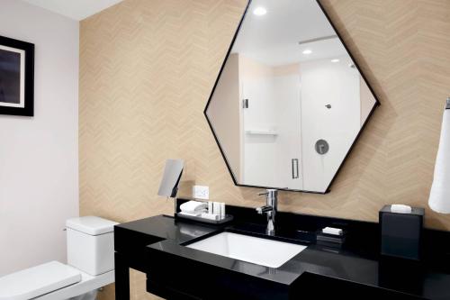 a bathroom with a sink and a mirror at Courtyard Boston Downtown/North Station in Boston
