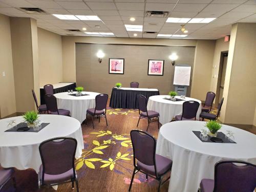 a conference room with white tables and chairs at Holiday Inn Toronto International Airport by IHG in Toronto