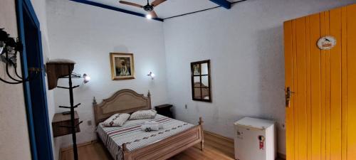 Ένα ή περισσότερα κρεβάτια σε δωμάτιο στο Casarão de Minas