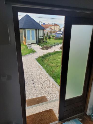 a view of a house through a window at The Vie Llage - Olive Tree double bungalow in Vagos
