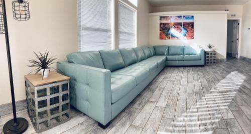a blue leather couch in a living room at HorseshoeBendHouse is Close to canyons Renovated recently with boat parking in Page