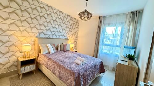 a bedroom with a large bed and a large window at Luxury Golf Apartman in La Cala de Mijas Golf in Mijas