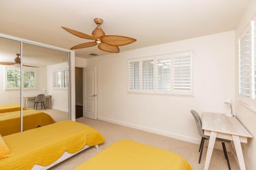 a bedroom with two beds and a ceiling fan at Villa Olina 3-Bedroom Walking Distance From Lagoons 30-day Minimum Vacation Rental in Kapolei