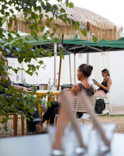 a woman sitting in a chair under an umbrella at The People - Tours in Tours