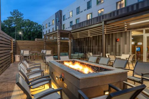 a patio with chairs and a fire pit in front of a building at Courtyard by Marriott Charleston-North Charleston in Charleston