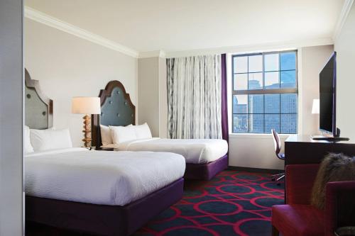 a hotel room with two beds and a window at Courtyard by Marriott Boston Downtown in Boston