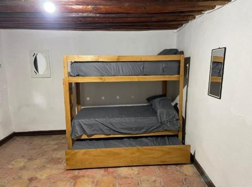 a bedroom with two bunk beds in a room at ESTANCIA CASA DE PIEDRA casa 2 in San Isidro