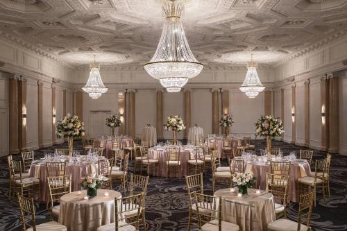 a banquet hall with tables and chairs and chandeliers at Courtyard by Marriott Boston Downtown in Boston