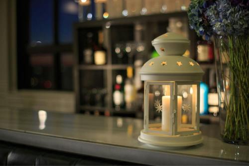 a lantern sitting on a table with a vase of flowers at Courtyard by Marriott Boston Downtown in Boston