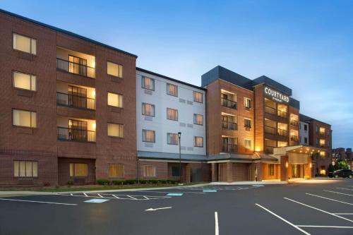 an empty parking lot in front of a hotel at Courtyard Worcester in Worcester