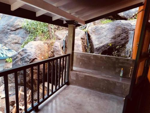 a balcony with a view of a waterfall at Nautilus Cottage Unawatuna in Unawatuna