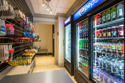 a store aisle with a large selection of soda sodas at Courtyard Worcester in Worcester