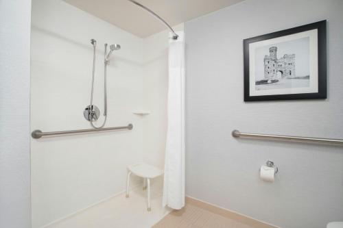 a bathroom with a shower and a toilet at Courtyard Worcester in Worcester