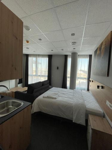 a bedroom with a bed and a sink in it at Apartamentos - Mirasur in Parla