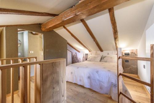 a bedroom with a bed in a room with wooden beams at La casa dello scoiattolo CIR COMUNALE N 20 in Gressan