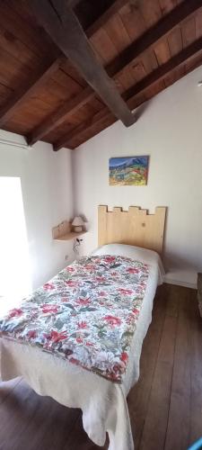 a bedroom with a bed with a quilt on it at Cèdres Bleus de Joany chez Nathalie in Viviez
