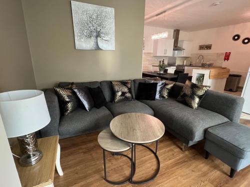 a living room with a couch and a table at Nearby Glastonbury, Next to Street Town Centre - Ground Floor Large 3 BD With Parking, Sleeps Up to 6 in Street