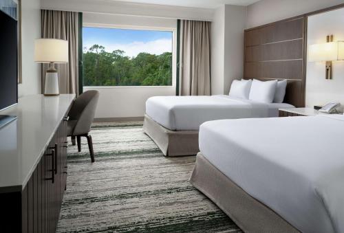 a hotel room with two beds and a window at Signia by Hilton Orlando - An Official Walt Disney World Hotel in Orlando