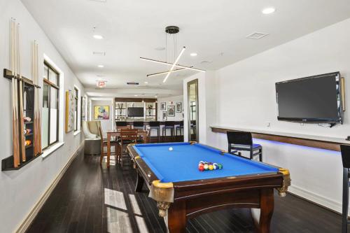 a living room with a pool table and a tv at Spacious Comfort Near Downtown Hotspots in Arlington