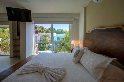 a bedroom with a large bed with a large window at Casa en Nuevo Vallarta in Nuevo Vallarta 
