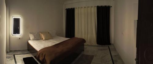 a bedroom with a bed in a room at Siddhi Homestay in Varanasi