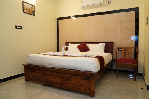 a bedroom with a bed with a swan on it at TPK Residency in Thanjāvūr