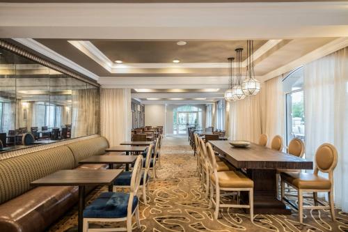 a row of tables and chairs in a restaurant at Courtyard by Marriott Charleston Historic District in Charleston